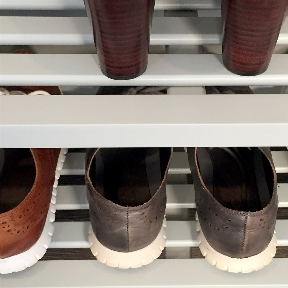 close up details of the slatted shelves on the grey shoe storage rack